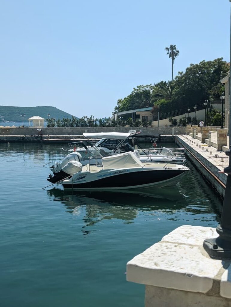 Waterfront view with several speedboats docked along the promenade in Portonovi, Montenegro