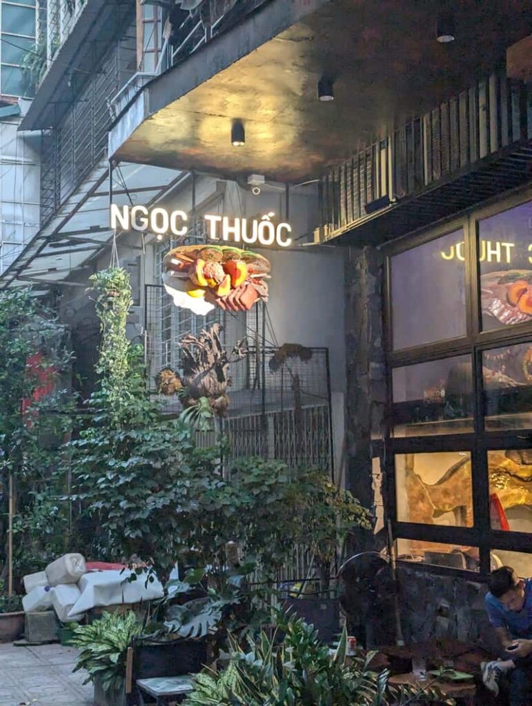 Bánh Mì Ngọc Thuốc, Hanoi, Vietnam outdoor seating area cost jungle vibes.
