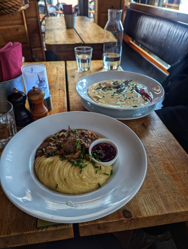 Traditional Norwegian fish soup and reindeer in Rorbua, Oslo, Norway